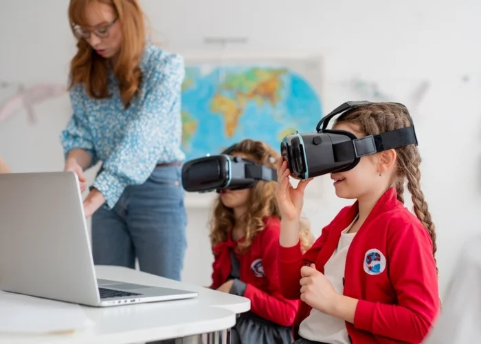 stock-photo-happy-schoolchildren-wearing-virtual-reality-goggles-at-school-in-computer-science-class-2169492743_(1)-transformed